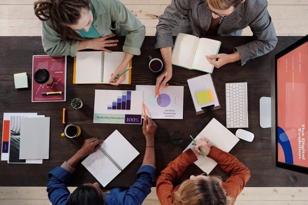 Overhead view of diverse professionals collaborating on a project in a modern office setting.