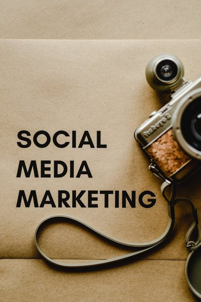 Close-up of a vintage camera next to a social media marketing concept text on a brown background.