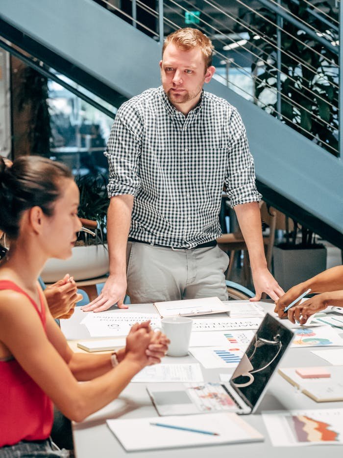 Business team collaborating around a table in a modern office setting.