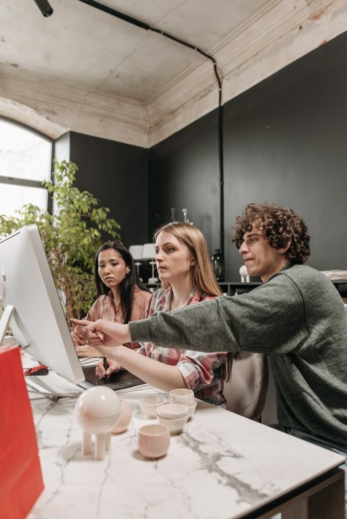 A diverse team discusses strategies in a modern office setting, using technology to enhance creativity.