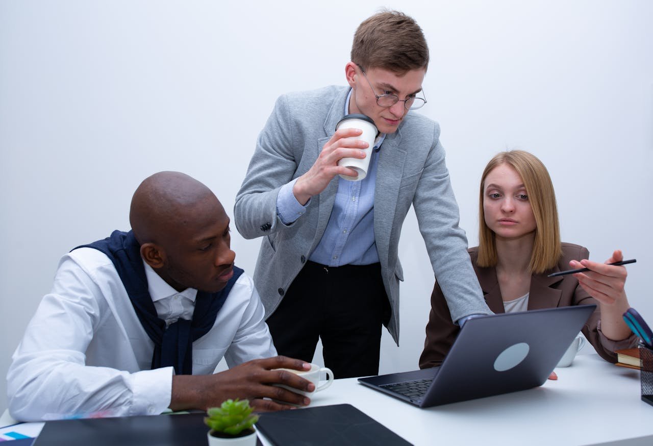 SBC Marketing London team collaborating around a laptop in the office