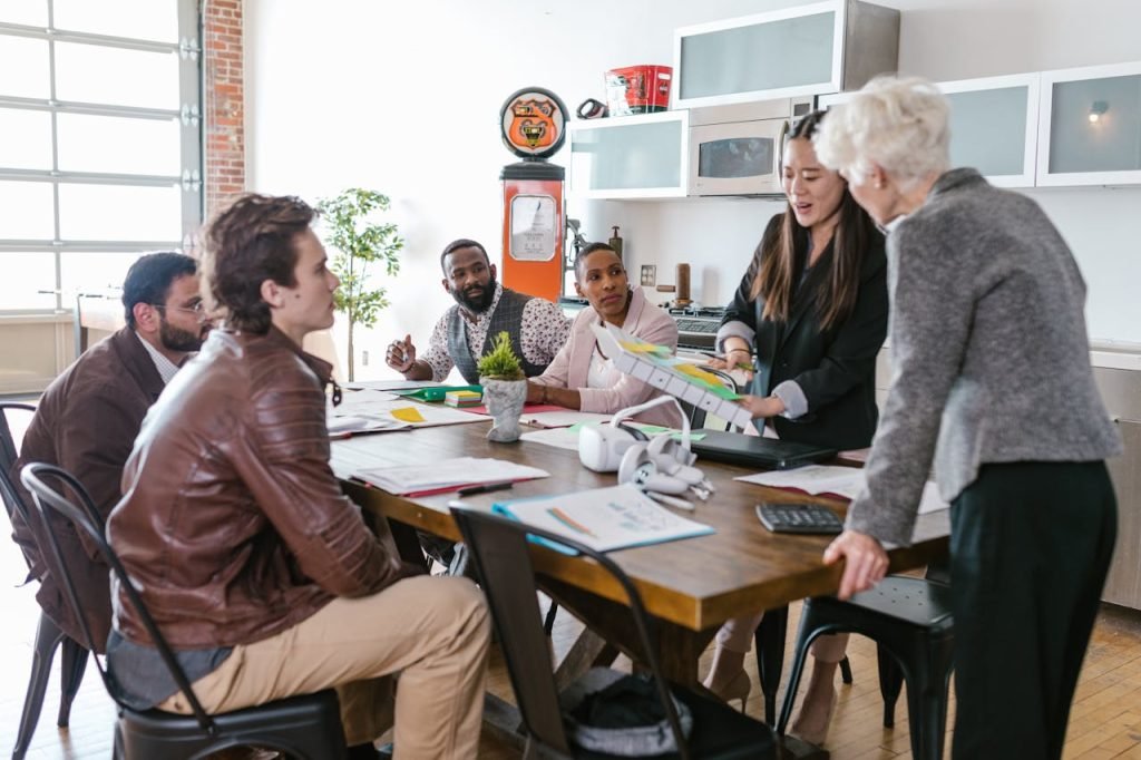 Colleagues engaged in a collaborative business meeting around a table in a modern office setting.