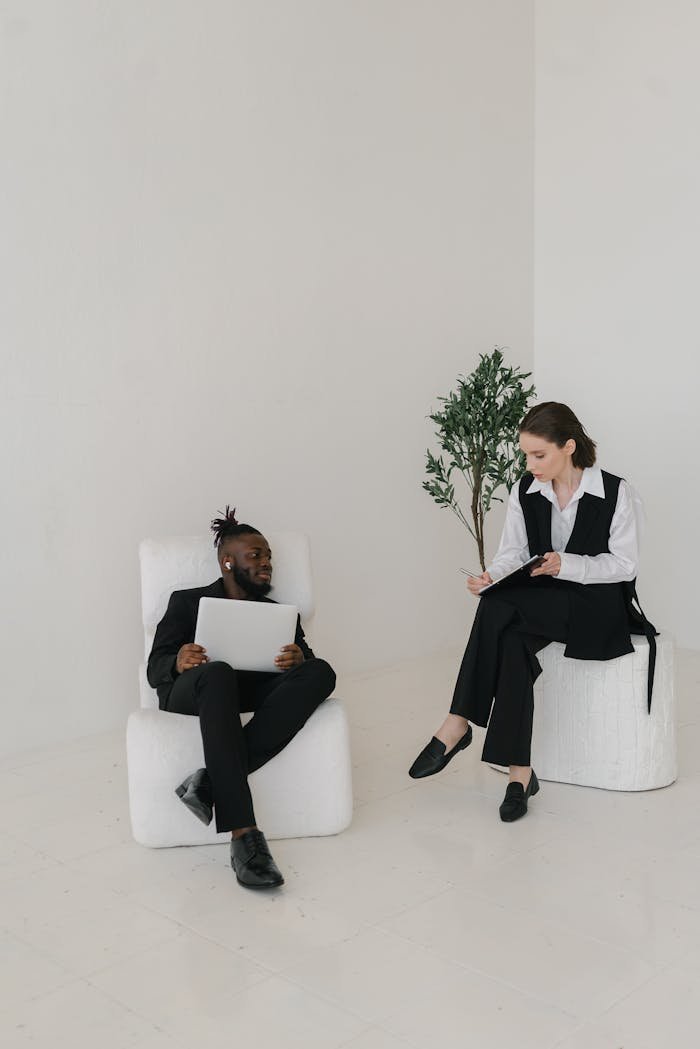 SBC Marketing London colleagues discussing work documents in a bright, modern office setting.